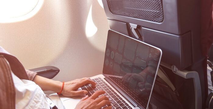 Nomad Digital Woman Hand  As She Is A Freelance Working  A Vacation With Laptop In  Airplane