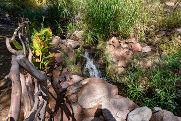 Small decorative waterfall on the territory of the Botanical Garden in the Eilat city, southern Israel