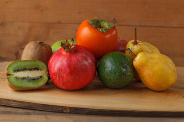 Group of fruits of yellow, red and green shades on a wooden table. Fresh fruits.