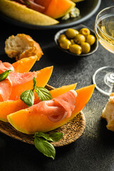 Naklejka na ściany i meble melon with parma and olives
