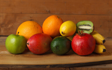 Group of fruits of yellow, red and green shades on a wooden table. Fresh fruits.