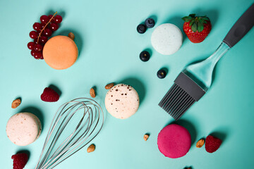 Close-up of macaroons of different colors in blue background. Culinary and tsuking concept. Tasti...