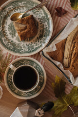 warm cupcake and coffee with antique dishes