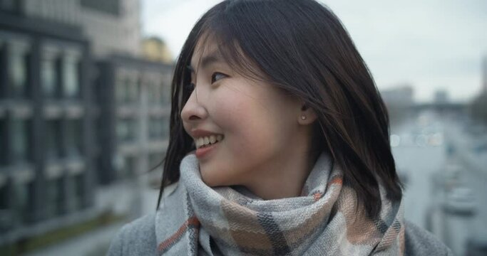 Portrait of a beautiful chinese happy woman looking at the camera. Young asian cute brunette girl on the background of the city. People. The beauty.