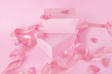 Valentine's Day styled photography mockup of pink lint, petals and boxes on a pink background.