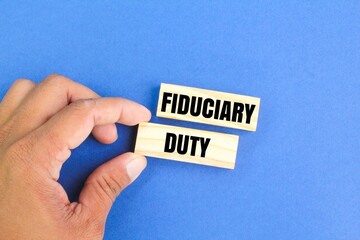 hand holding a stick with the word fiduciary duty. Financial and economic concepts. Financial concept.