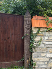 Traditional hinge made from wood. Hinge with symbols. Chidea village from Cluj. Carved male figure on a wooden hinge