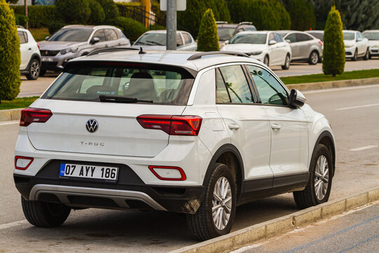 Side, Turkey -January 21, 2023:  white Volkswagen T-Roc   is parked  on the street on a warm summer day against the backdrop of a buildung, trees