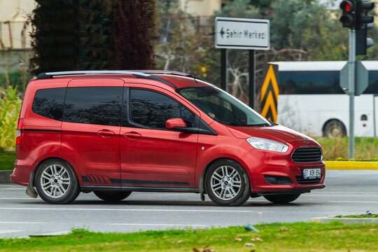 Side, Turkey -January 21, 2023:    red Ford Tourneo Courier   driving on the street on a warm summer day