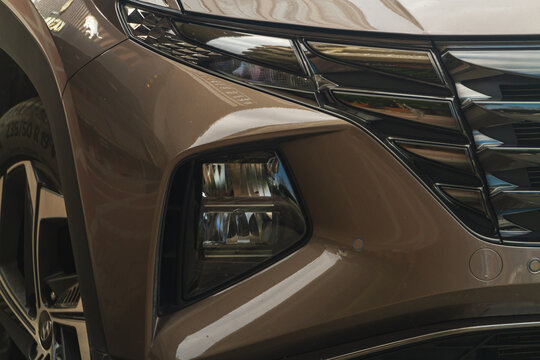 Side, Turkey -January 21, 2023:   Hyundai Tucson , side of brown  car with clear light headlight, bumper,  foglights