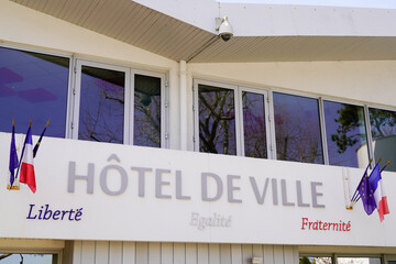 hotel de ville french text means city hall facade in town center with french flag of France