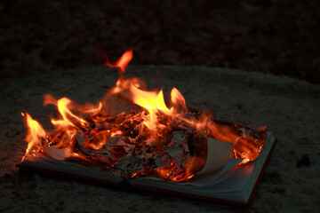 A burning book on the ground