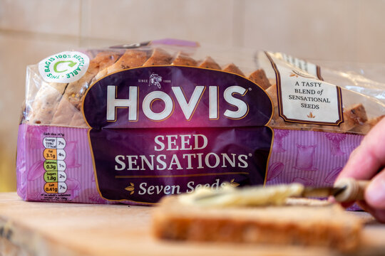 London. UK- 01.22.2023.A package loaf of Hovis Seed Sensation bread on a kitchen wooden board.