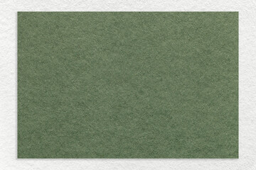 Texture of craft green color paper background with white border, macro. Structure of vintage dense...