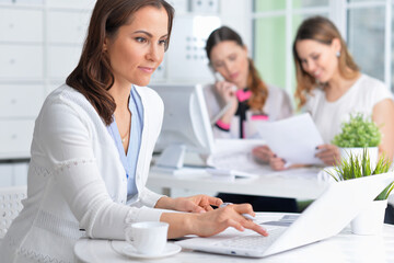 Fototapeta premium young women sit at the table and work in a modern office