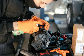 Car mechanic working in a garage