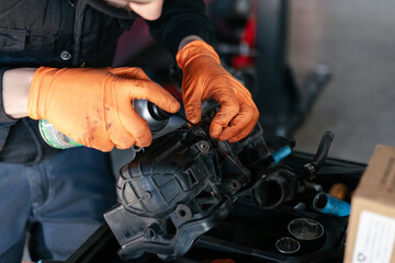 Car mechanic working in a garage