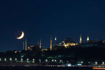 Fototapeta na wymiar Ramadan concept. Crescent moon with Ayasofya or Hagia Sophia and Blue Mosque