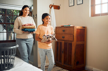 Cleaning, child and mother doing laundry clothes, house work and fold clean fabric, cotton or...