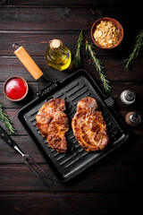 Grilled pork steak in a frying pan. 