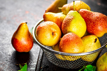 Ripe pears in a colander. 