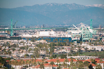 View of the port of Los Angeles, with Mt San Antonio covered with snow in the background. Taken in San Pedro, Los Angeles, California, USA.