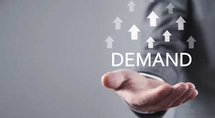 Male hand showing growing arrows and inscription Demand. Business