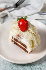Layered white chocolate cake on a stone background. A slice of delicious strawberry cake. close up