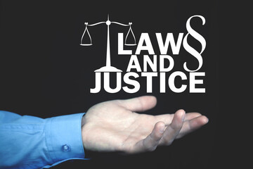Male hand showing Law and Justice concept.