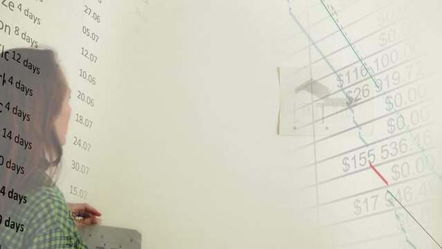 A woman pins a house plan to a white wall and digital graphs and calendar plans with diagrams move along it. Dream achievement concept. Computer graphics