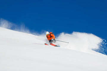 Free-rider skier alone in powder snow