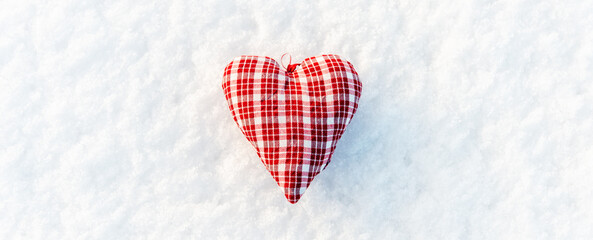 A red heart flat lay on the snow top view, valentines day concept.White snow background.Copy space.Banner.