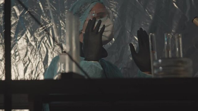 Mobile forensic laboratory. A man of Arab appearance Laboratory assistant researcher is preparing for work. Investigation of the object at the crime scene in a protective tent.