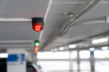 Close up to overhead LED status light of car parking in department store building parking.