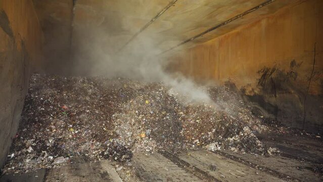 Heap of organic waste at compost recycling station. Bad quality organic waste polluted with plastic garbage at city waste management plant. Waste with organic and plastic trash. 4k ProRes footage