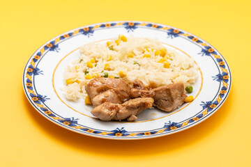 chicken fillet baked with sauce and boiled rice with vegetables