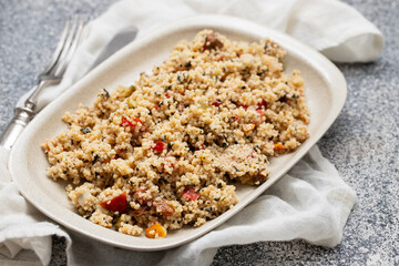 Couscous with vegetables in a dish with fork