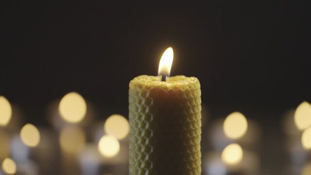 A candle is extinguished. Candlelight flickers in the background. Beautiful romantic atmosphere at home. The candle goes out and smoke appears. High quality 4k footage