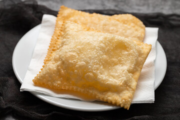 typical brazilian fried pastry on white plate