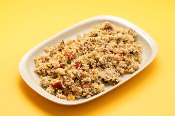 Couscous with vegetables in a dish with fork