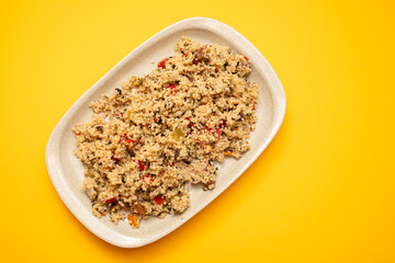 Couscous with vegetables in a dish with fork