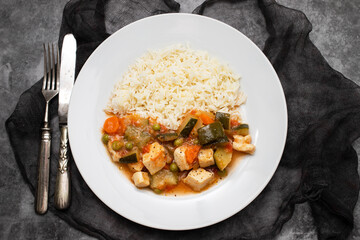 squid stew with vegetables and boiled rice on plate