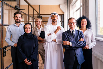 Multiracial group of corporate businesspeople working in a business office - Multiethnic businessmen and businesswomen meeting in the office in Dubai, UAE
