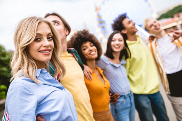 Multiracial young people together meeting and social gathering - Group of friends with mixed races having fun outdoors in the city- Friendship and lifestyle concepts