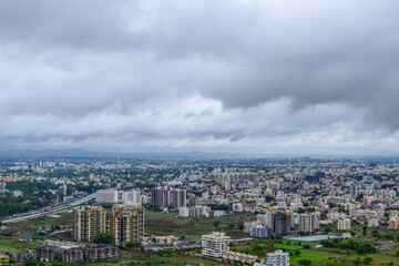 A clear top view of City in India from top of the mountains during rainy season.