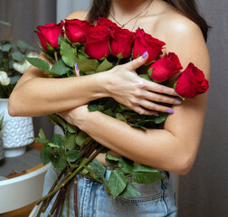 Woman covering her body with red roses