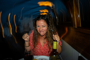 dinner and red wine with party girl deliberately blurry background for intoxicating feel. The...