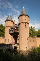 Fototapeta na wymiar outside entrance gate of Kasteel De Haar Dutch medieval castle on sunny summer day. Shutters have colour of Utrecht Netherlands where historic building with European architecture is located
