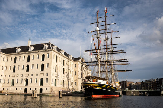 Clipper Stad Amsterdam docked at the National Maritime Museum in Amsterdam. This impressive sail ship makes for a perfect photo opportunity to passing by tourists. 