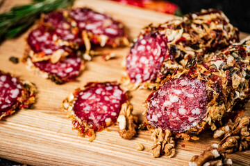 Pieces of salami sausage on a cutting board. 